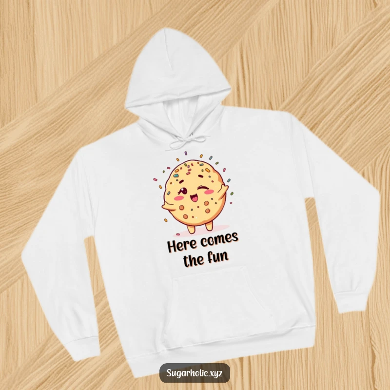 Funny winking cookie character showering colorful sprinkles, creating a warm and humorous hoodie.