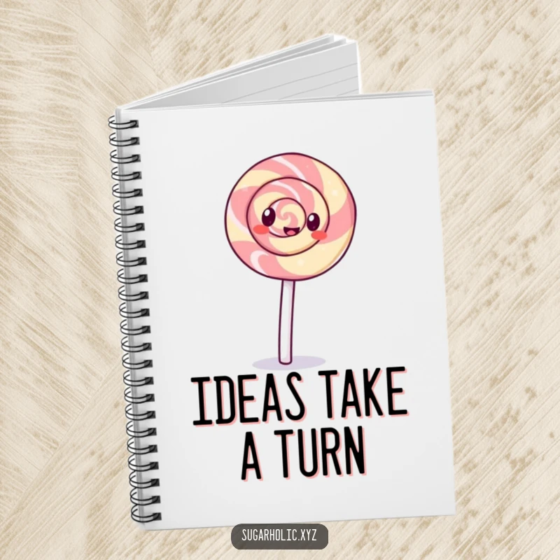 Funny giggling lollipop with a swirl pattern doing a cartwheel on a notebook, inspiring fun notes and playful journaling.
